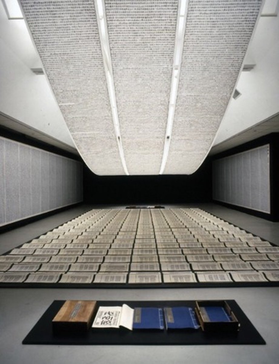 <p>Xu Bing</p><p>1987-1991 CE</p><p>Form: Mixed-media installation</p><p>Function: Features hand-printed books and scrolls.</p><p>On the walls are rows of paper filled with what looks to be Chinese characters. On the floor are rows of open hand-bound books also filled with the Chinese characters, the forms wave as if they are part of the sea. Above them hang three long scrolls as if they were the sky, they too are filled with the Chinese lettering. The letters were created using carved wood blocks, a type of movable press that dates back to the 8th century Tang Dynasty. The one difference is that Xu Bing made up all of the letters used in the work to look like Chinese characters, they are all invented calligraphic letters that have no meaning.</p>