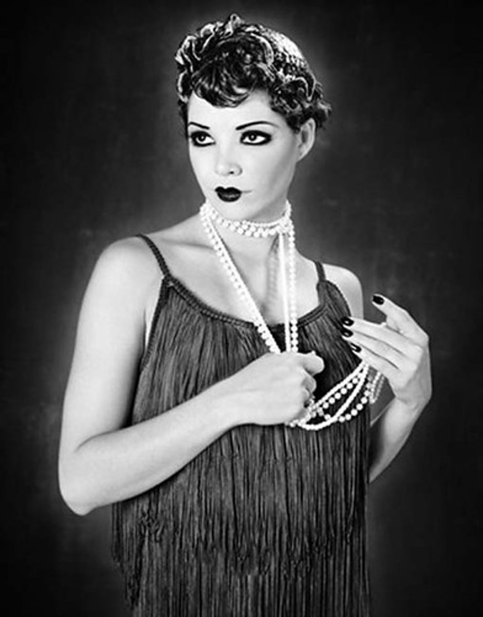 <p>carefree young women with short, "bobbed" hair, heavy makeup, and short skirts. The flapper symbolized the new</p><p>"liberated" woman of the 1920s.</p>