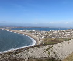 <p>formed when a spit extends across a whole bay and rejoins the land forming a lagoon behind it</p>