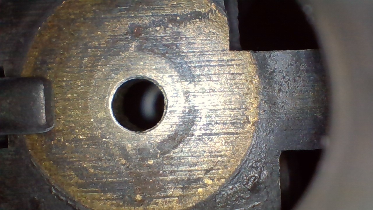 <p>What type of machining likely created the continuous parallel lines seen on this breechface?</p>