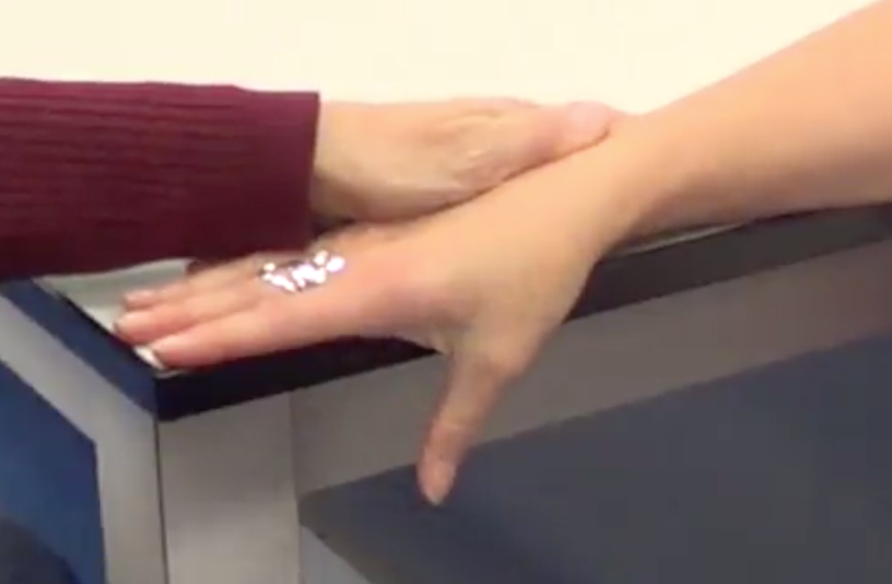 -Forearm pronated on the table with their test thumb hanging off the table
-Stabilizng dorsum of hand