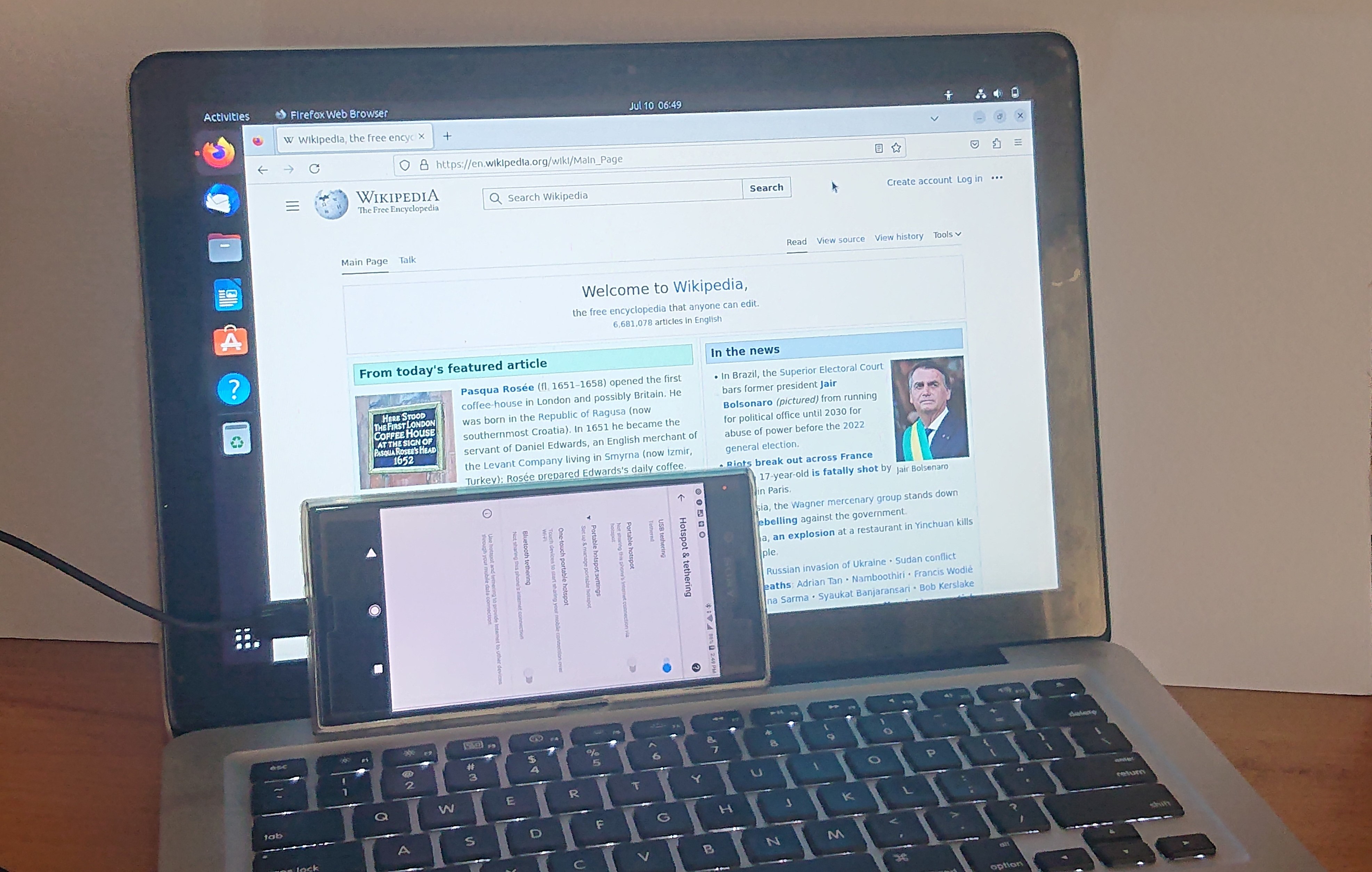 <p>The act of <strong>connecting one device to another</strong> (usually a smartphone to a laptop or tablet) so the second device can <strong>access the internet using the first device’s mobile data connection</strong>.</p>
