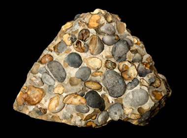 <p>Sedimentary, lots of variety of rocks sizes, and colours</p>