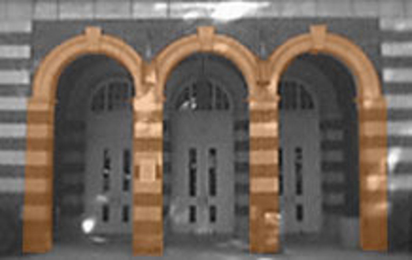 <p>A series of arches supported on piers or columns. A "blind" arcade is a row of arches applied to the wall as an ornamental feature.</p>