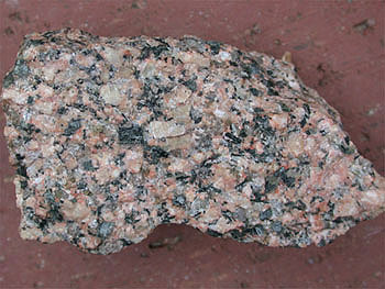 <p>-igneous</p><p>-plutonic</p><p>-phoneritic</p><p>-felsic</p><p>-<strong>K-feldspar</strong>, quartz, Na-plagioclase</p><p>-formed at the low temp extreme of BRS</p><p>uses: countertops</p>