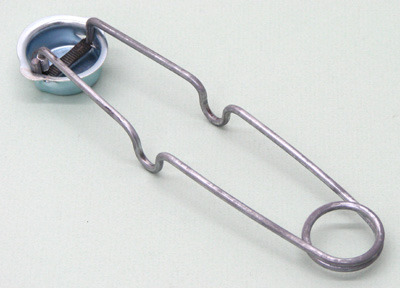 A long metal device with a movable arm that has a piece of flint on the end