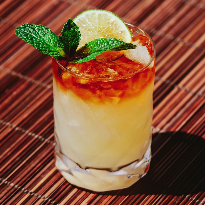 <p>sour, 1 oz light rum, 1 oz dark rum, 0.5 triple sec, 0.75 orgeat syrup, 1 oz lime juice, dash angostura, served on the rocks, garnished with lime/mint</p>