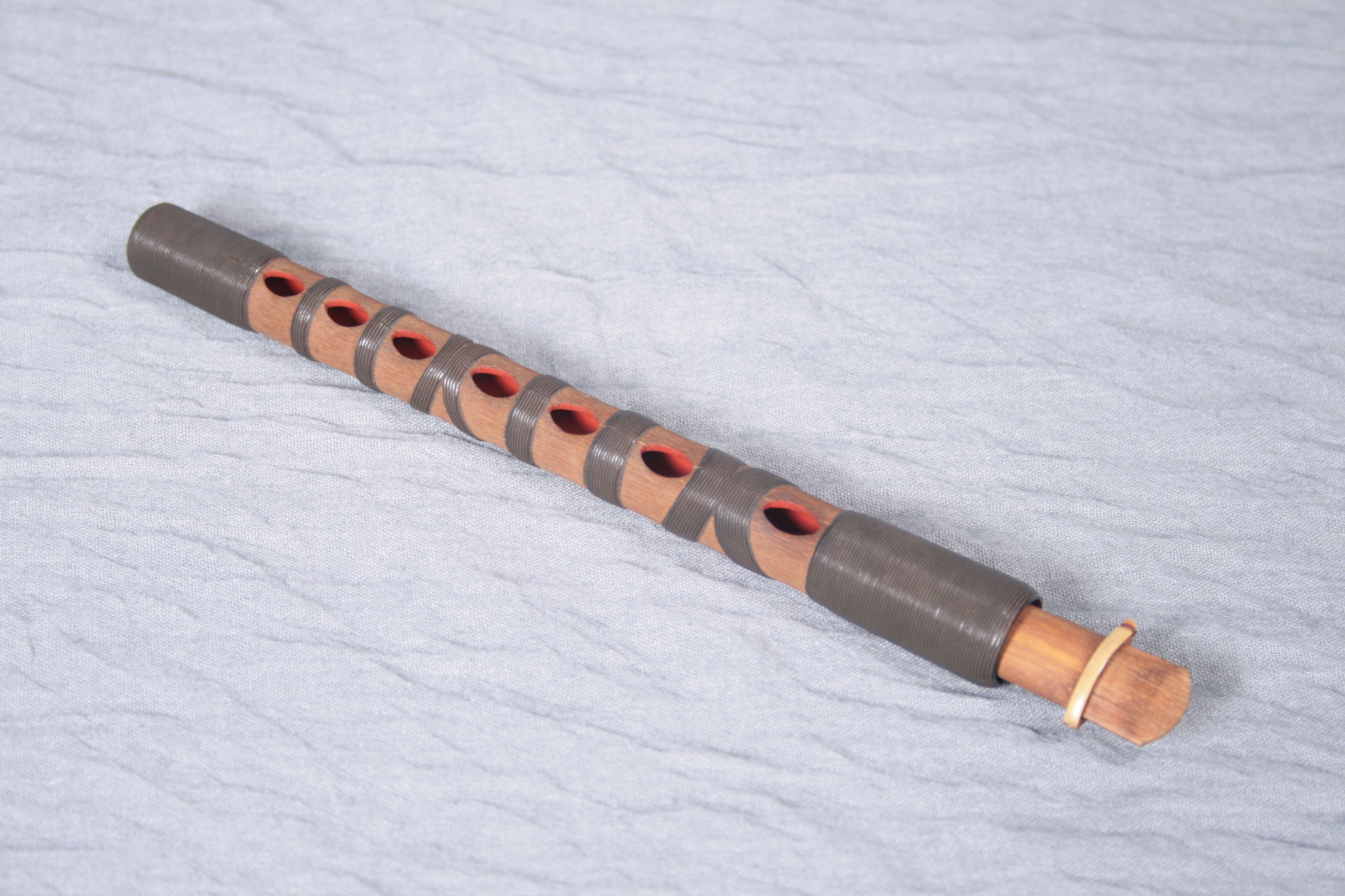 <p>The ______ is a ______-holed double reed instrument made of ______. It is an ______.</p>