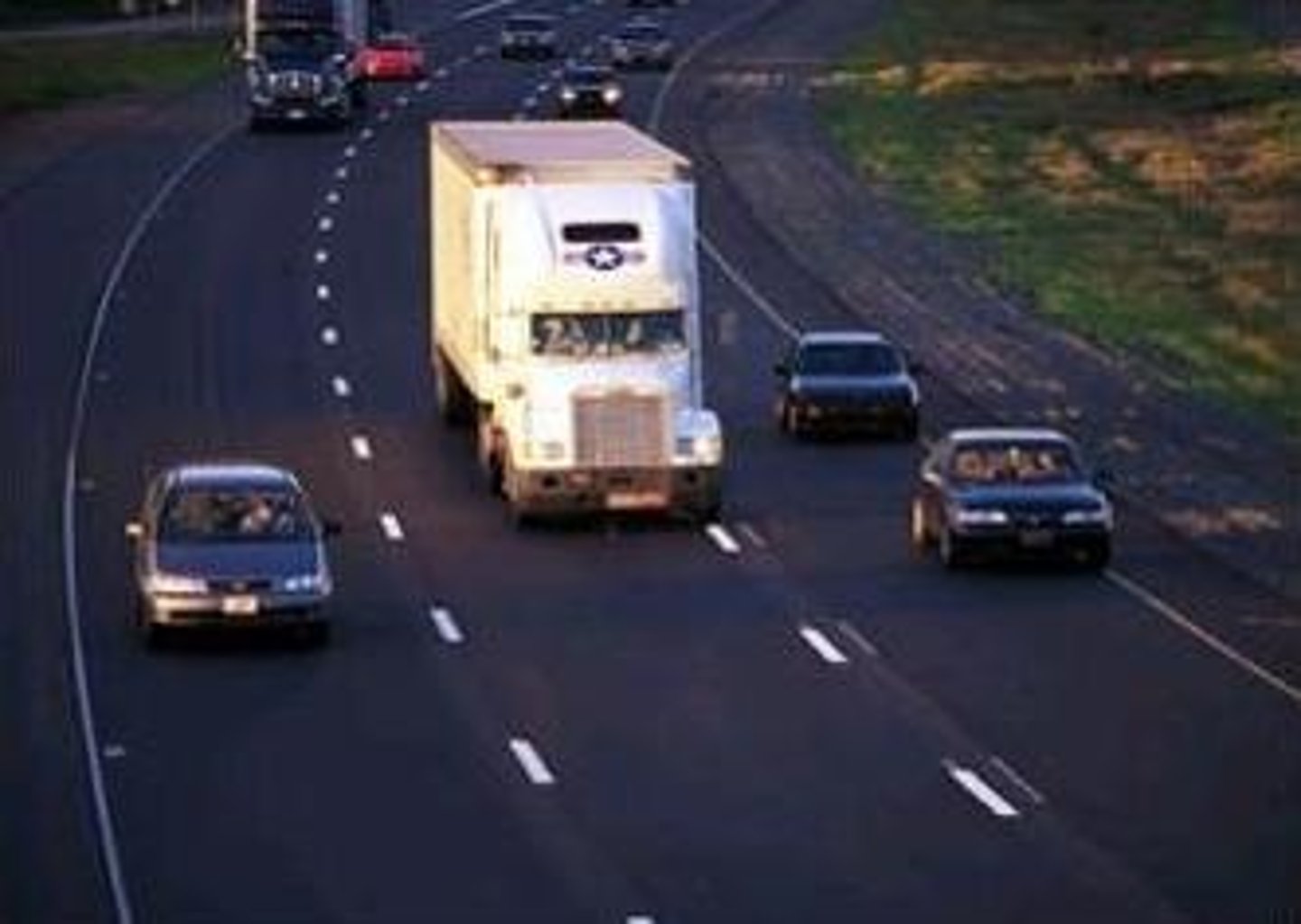 <p>Between lanes of moving traffic in the same direction that indicate you may cross to change lanes if it is safe to do so</p>