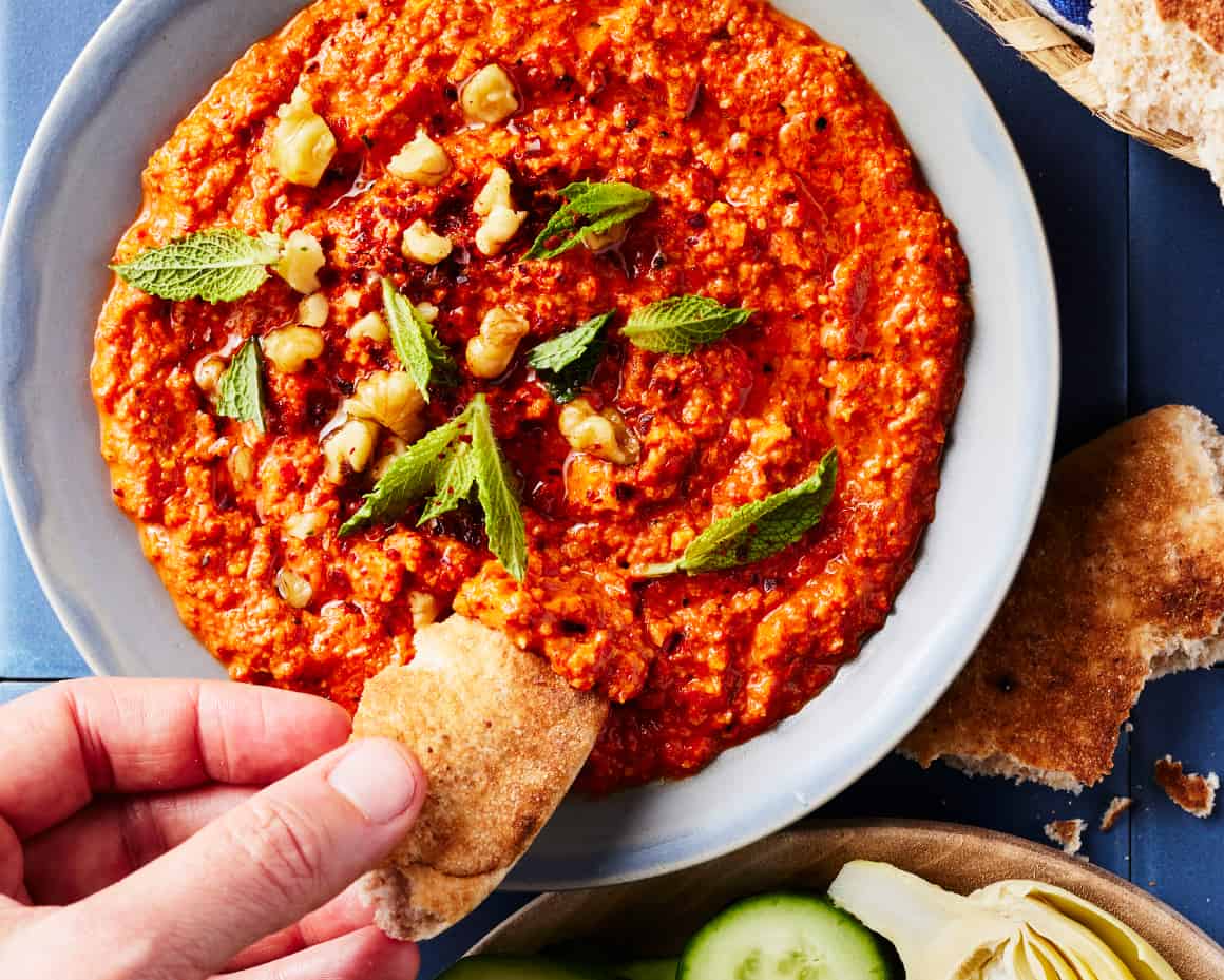 <p>muhammara <strong> </strong>(literal meaning “reddenned” spicy red bell pepper dip)</p>