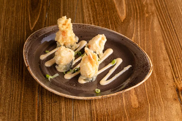 <p>Crab mix stuffed shrimp tempura with creamy house sauce with green onion</p>