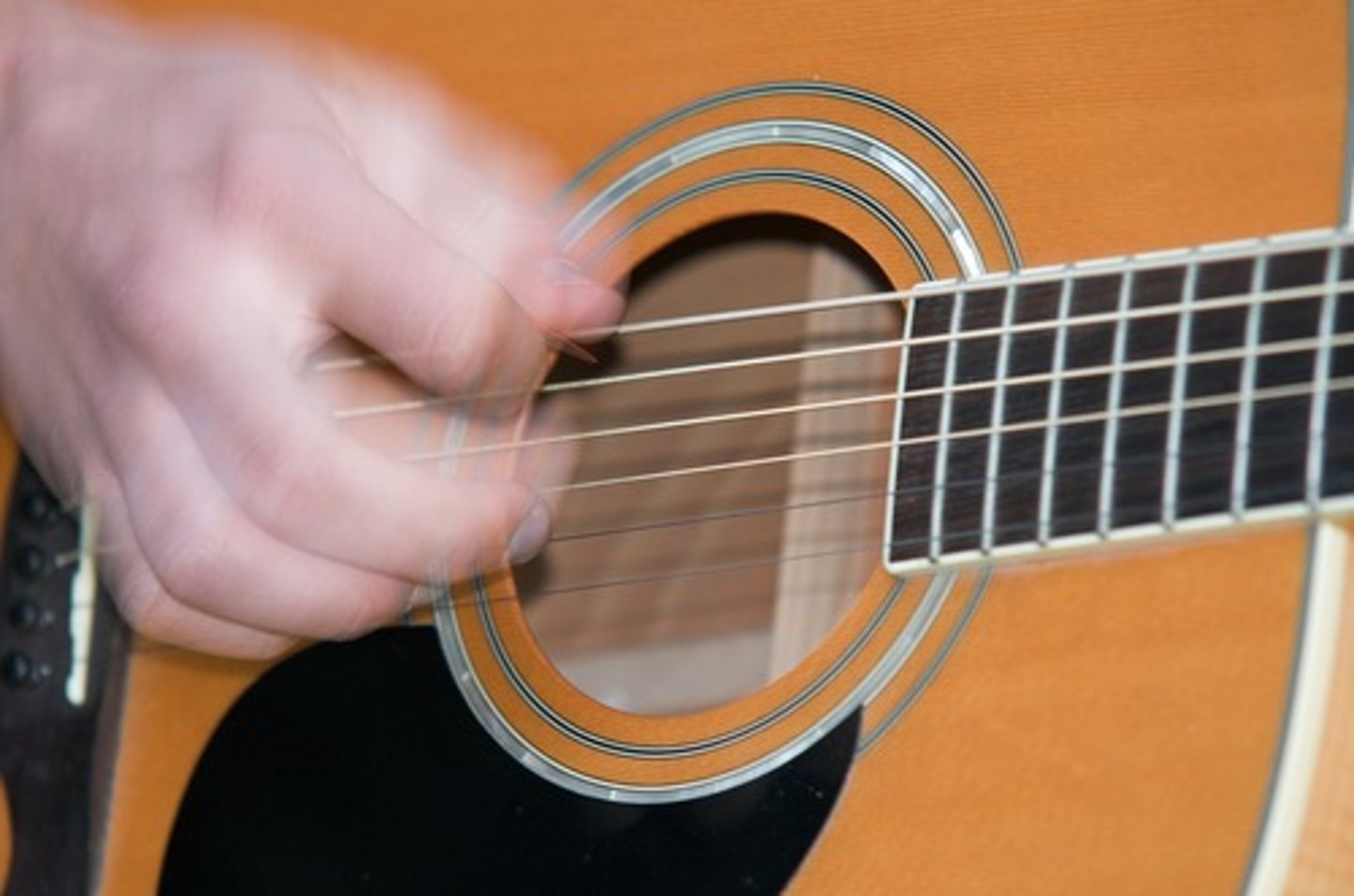 <p>to make music by stroking or brushing the strings of an instrument</p>