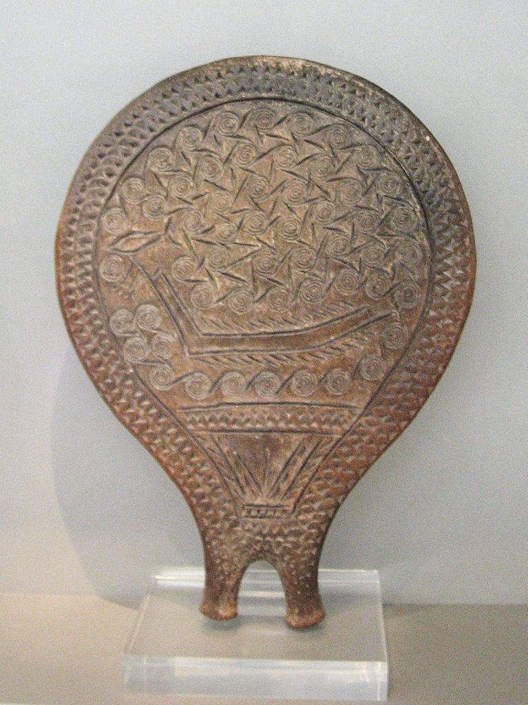 <p>clay, depiction of a long boat, swirls depict wind/water/journeying, pubic triangle at the bottom</p>