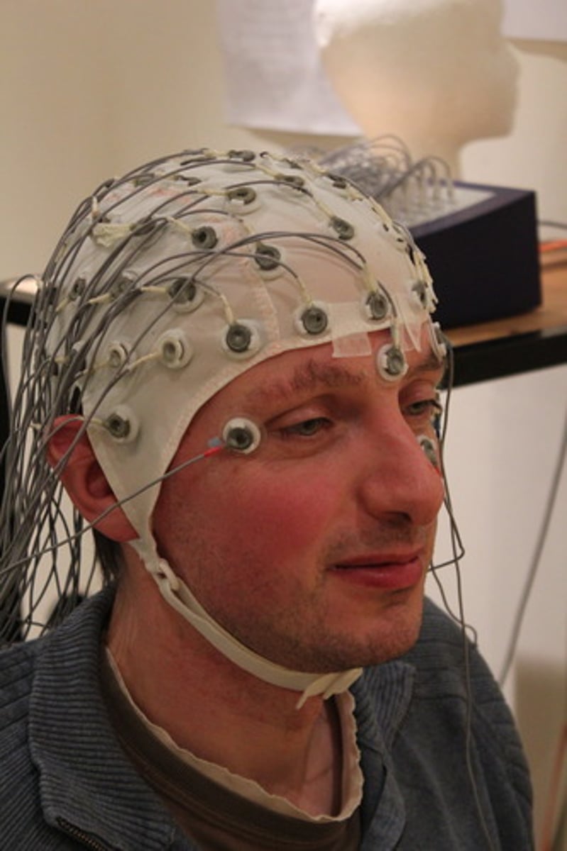 <p>Recording the electrical activity of the brain via electrodes on the scalp.</p>