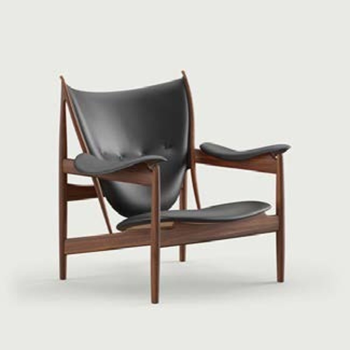 <p>Finn Juhl's sculptural chair with an exposed teak frame and shaped dark green leather seat and back was designed for Niels Vodder of Denmark.</p>