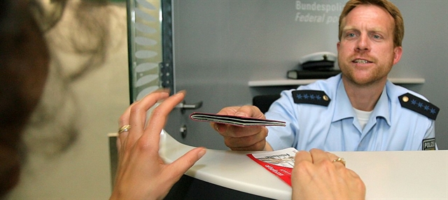 a government employee who examines the passports, visas, etc of foreign nationals enteringthe country at a port, airport, etc