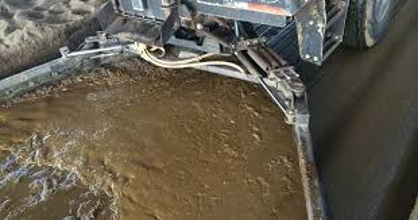 <p>Pit immediately under floor holding animals- slotted floor, periodically pumped as fertilizer</p>