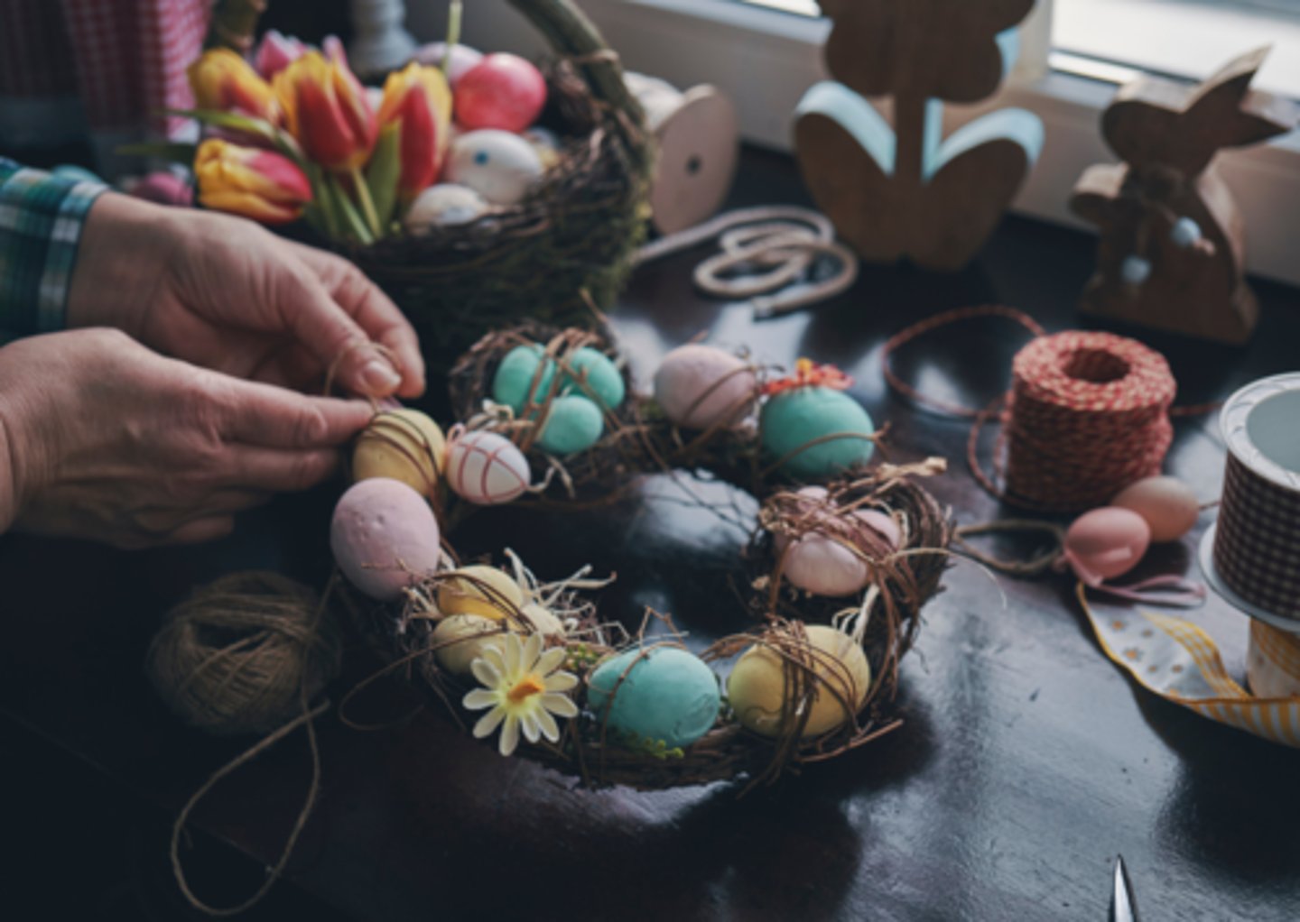 <p>add decorations like flowers or ribbons to a ring made of branches for a celebration</p>