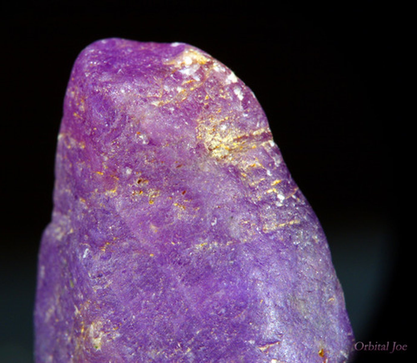 <p>Very hard reddish or purplish rock, Often has small column-like opaque crystals. Vitreous.</p>