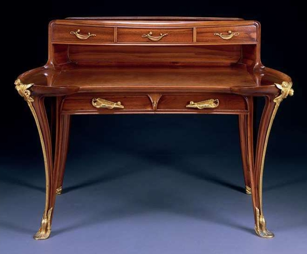 <p>Artist of this mahogany desk with ormolu mounts. This desk has the characteristic flowing lines following Hogarth’s “Line of Beauty,” and the curvilinear, nature-inspired ornamentation of the turn of the century. </p>