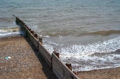 <p>hard engineering is controlled disruption of natural processes by using man-made structures, e.g groynes, sea walls, rock armour</p>