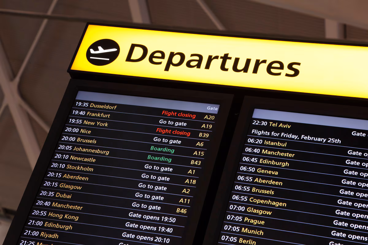 a board in an airport, bus terminal, etc displaying the times and destinations of future departures