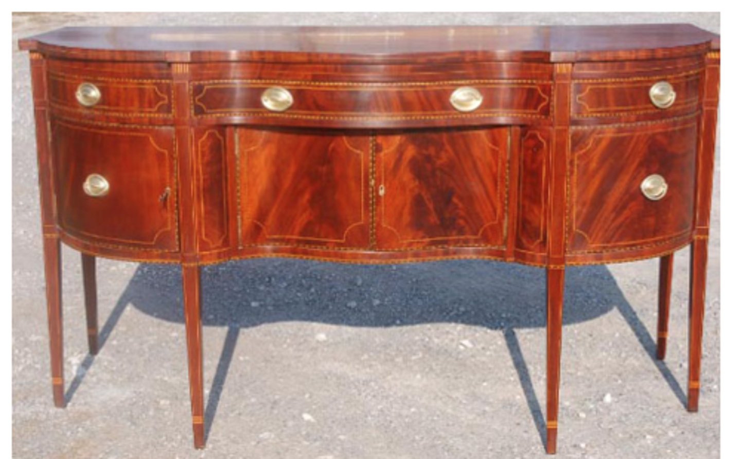 <p>straight lines</p><p>tapered legs</p><p>delicate oval brass pulls</p><p>pattered veneered wood</p><p>mahogany</p><p>very simple</p>