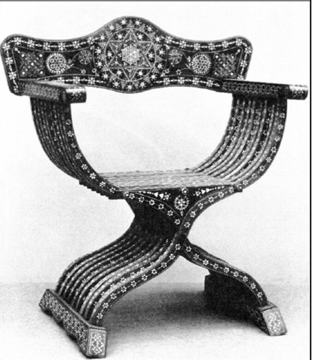 <p>Consisted of about 7 serpentine x-shaped staves. Lower staves were secured with a runner foot while upper staves were secured by straight arms. Had flat arched back rail (wood) joined to the rear ends of the arms. Narrow seat made of slats and loose cushion was usually placed on seat.</p>