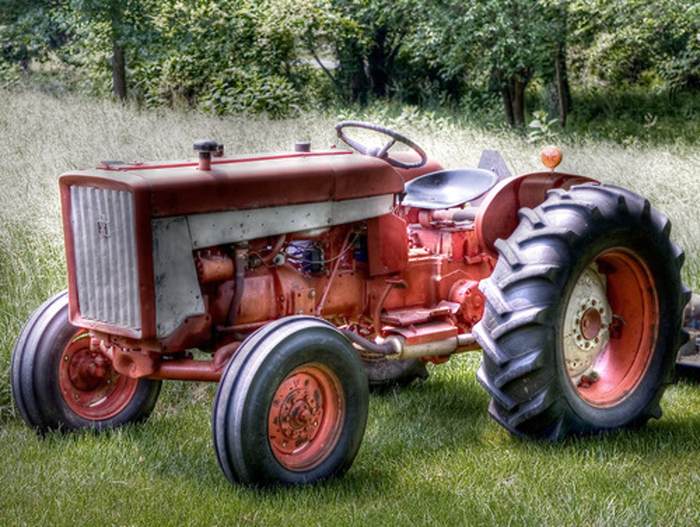 <p>a powerful motor vehicle with large rear wheels, used chiefly on farms for hauling equipment and trailers</p>