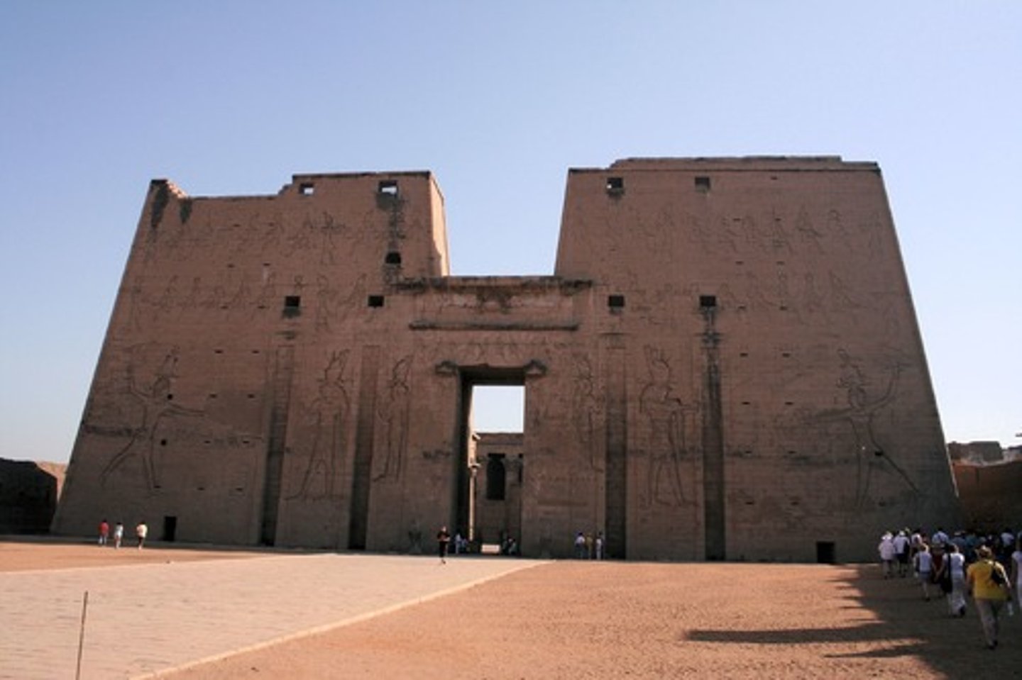 <p>A monumental gateway to an Egyptian temple marked by two tower structures with sloping walls flanking the entrance portal</p>