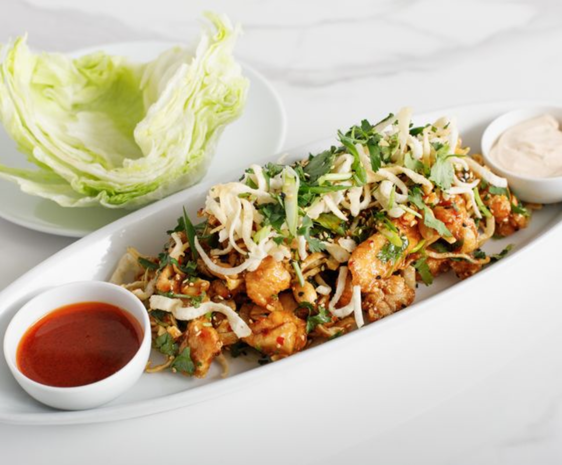 <p>Crispy Fried Tofu or Locally Raised, Free Run Chicken</p><p>Sweet, Spicy Szechuan Sauce Peanuts, sesame seeds, crispy wontons, green onions, cilantro, korean chili sauce, and spicy yogurt.</p><p></p><p>100% plant based if ordered with tofu and no spicy yogurt, and no wontons.</p>
