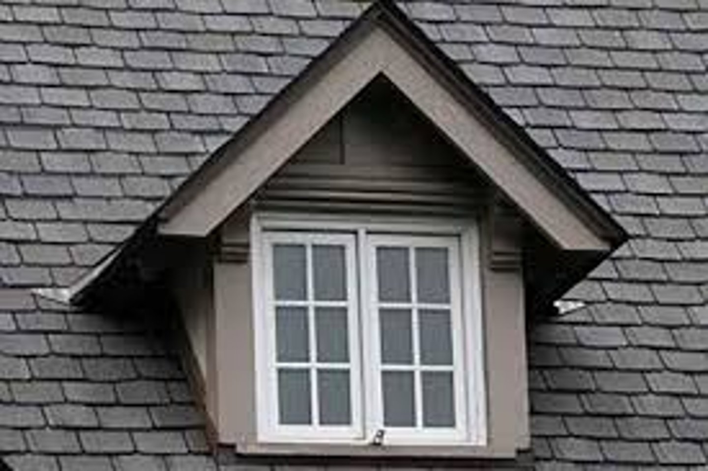<p>A vertical window in a projection built out on a sloping roof</p>