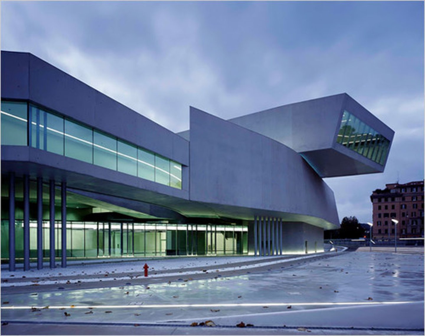<p>Rome, Italy</p><p>Zaha Hadid (architect)</p><p>2009 CE</p><p>Form: Glass, steel, and cement</p><p>Function: Changed all of the rules of forms of architecture.</p><p>This museum was designed with an overall theme of movement. The building is constructed into what looks like overlapping and intersecting oblong tubes. The interior is covered by a glass roof, allowing natural light to flow into the structure. The walls curve into one another.</p>