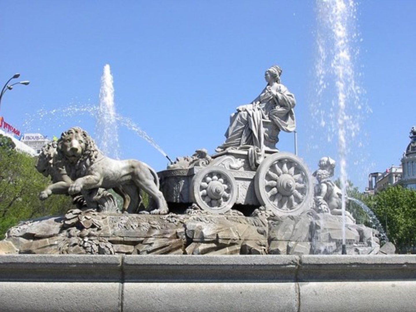 <p>An iconic fountain in the middle of a traffic circle in Madrid</p>