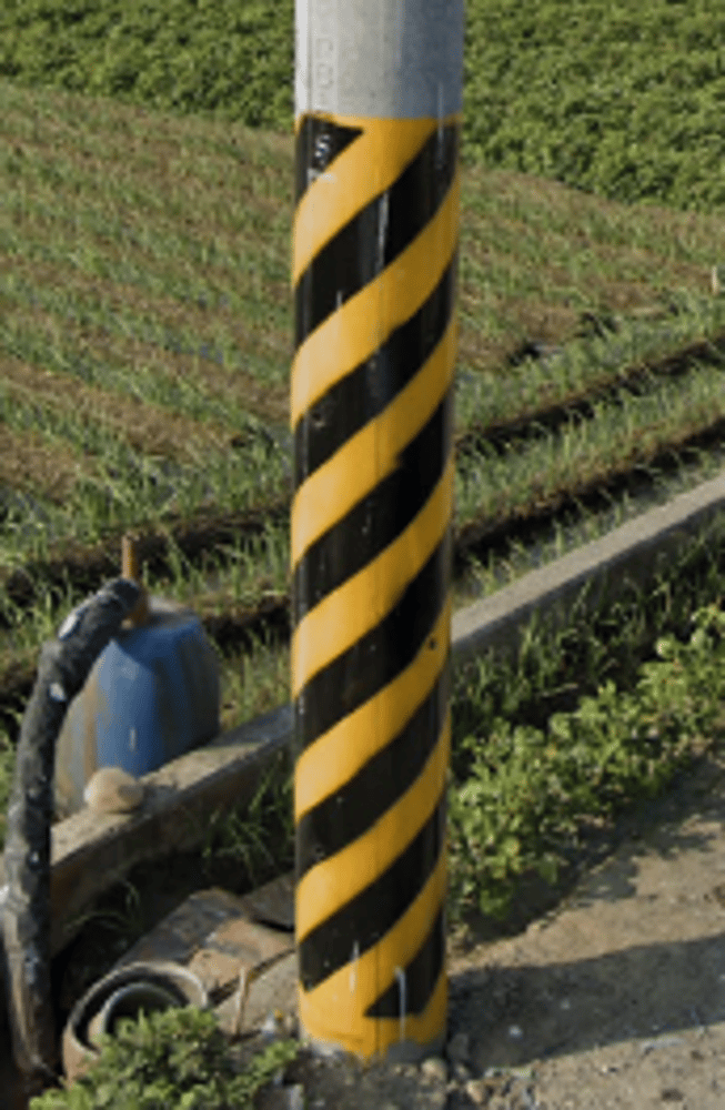 <p>Black and yellow diagonal stripes on poles</p>