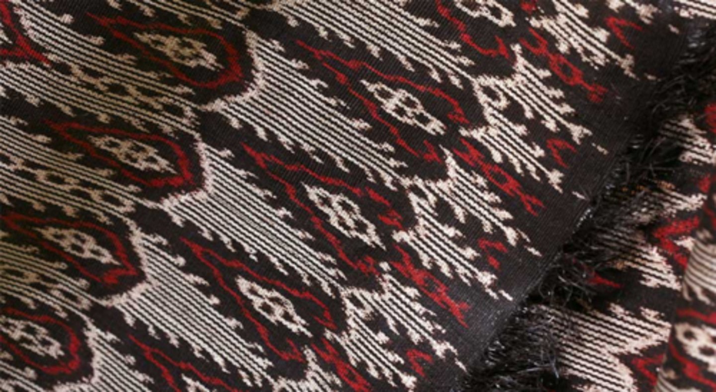 <p>Begins with stripping the abaca stem for fibers. The thread is dried, hand-tied strand by strand, then mounted on a frame where selected threads are tied to resist dye. These tied bundles determine the cloth's design. The t'nalak is woven on a backstrap loom, which strains the weaver's back and eyes.</p>