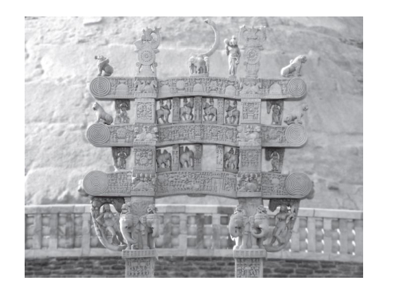 <p>“a gateway near a stupa that has two upright posts and three horizontal lintels. They are usually elaborately carved”</p>