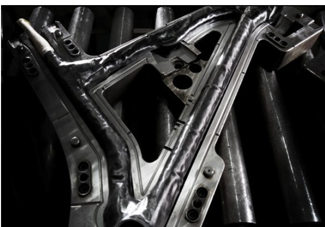 What process is being used to create the Scott Advert bicycle frame shown?