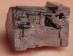 * Cannot scratch glass
* Cannot be scratched with fingernail or penny
* Is not magnetic 
* Has a dark grey streak