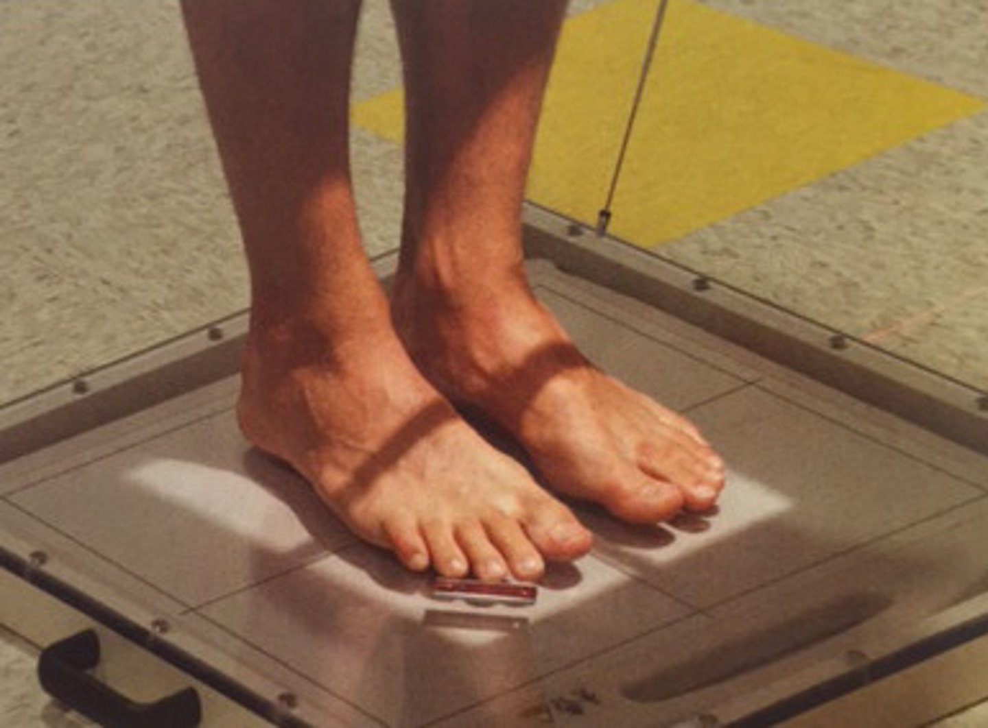 <p>angled 15 degrees posterior to midpoint of feet at level of base of metatarsals</p>