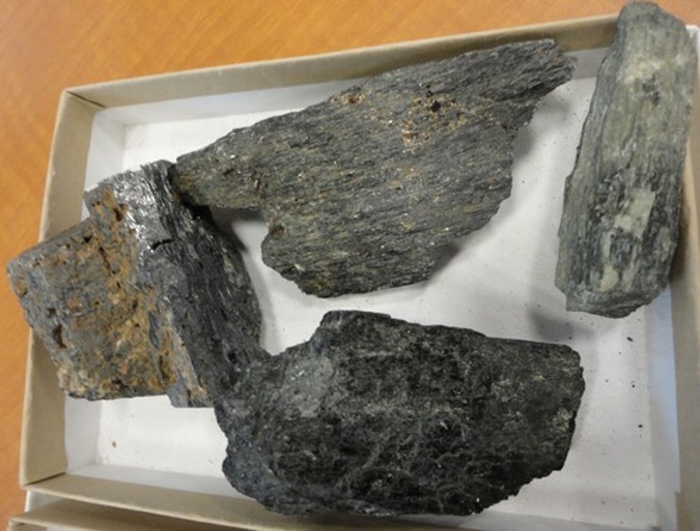 <p>Rock-forming mineral; hardness 5-6 (harder than glass), black to dark green, 2 cleavages meet nearly at 90 degrees (good cleavage)</p>