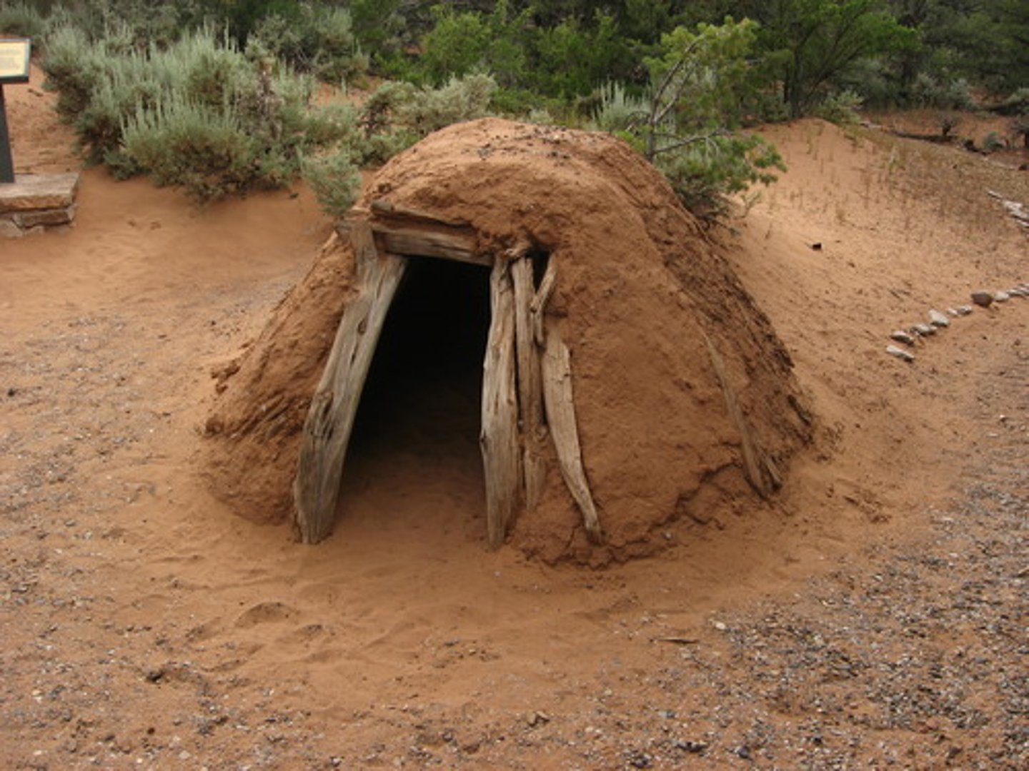 <p>a cone-shaped Navajo shelter built by covering a log frame with mud or adobe</p>