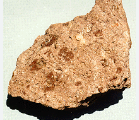 <p><span>a light, <u>porous</u> rock formed by the <u>consolidation</u> of <u>volcanic</u> ash.</span></p>