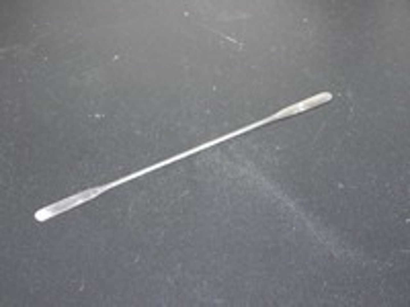 <p>A small, micro spatula with two different sides that is used to scoop up small samples of solids.</p>