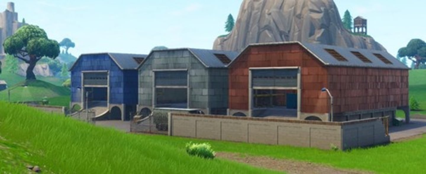 <p>a building where supplies or vehicles, especially buses, are kept</p>