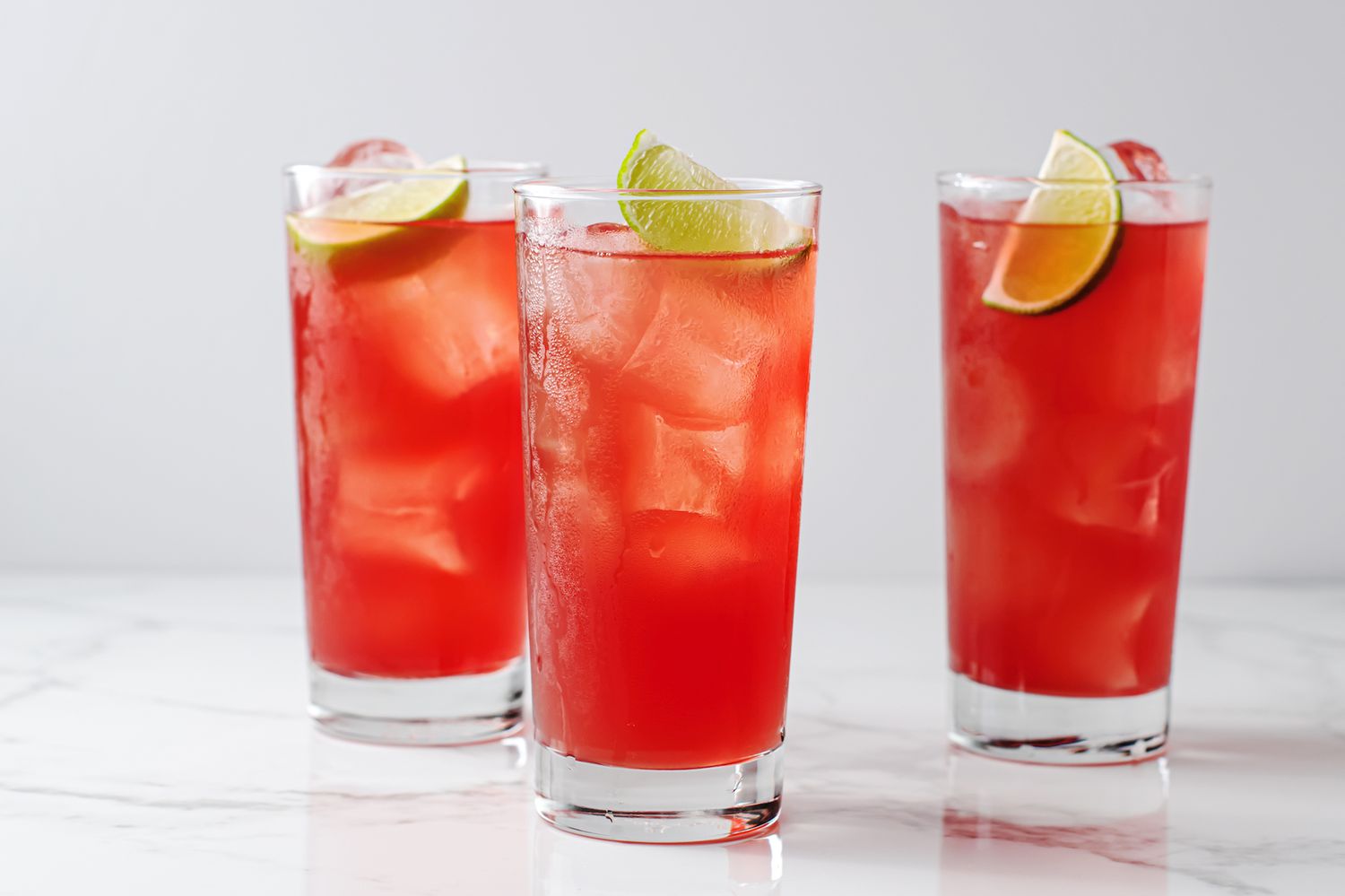 <p>highball, 1.5 oz vodka, 2 oz orange juice, 2 oz cranberry juice, served in a Collins, garnished with lime</p>