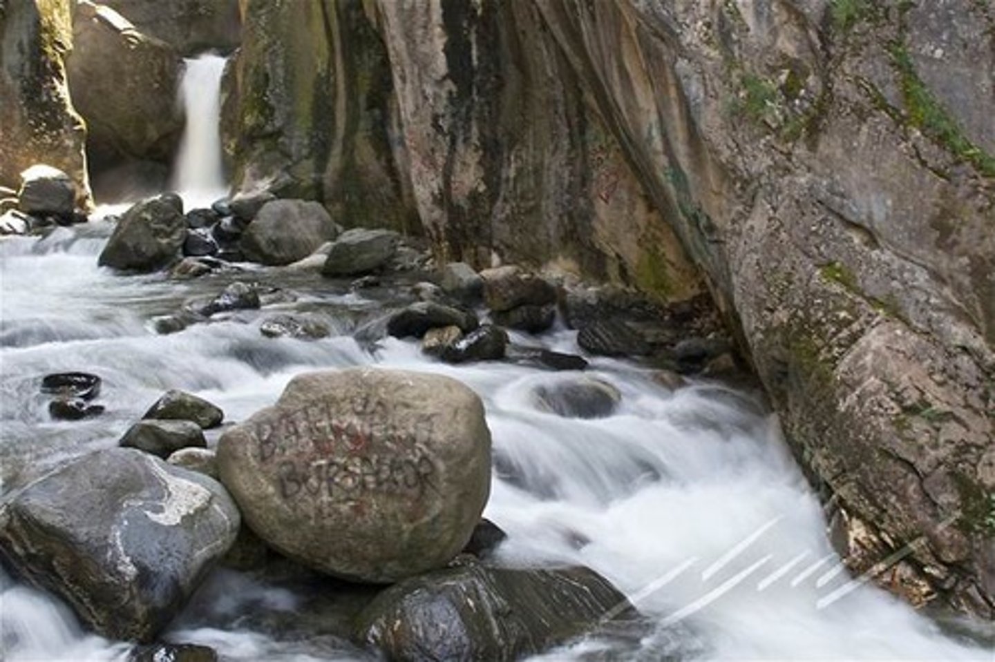 <p>This is a type of erosion; it is the force of the water as it slams against the bed and banks and rips chunks out of them.</p>
