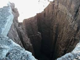 <p>a large hole in the ground; a difficult or dangerous situation.<br></p>