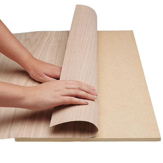 <p><span>A thin decorative covering of fine wood applied to a coarser wood or other material. An attractive appearance that covers or disguises someone or something's true nature or feelings.</span></p>