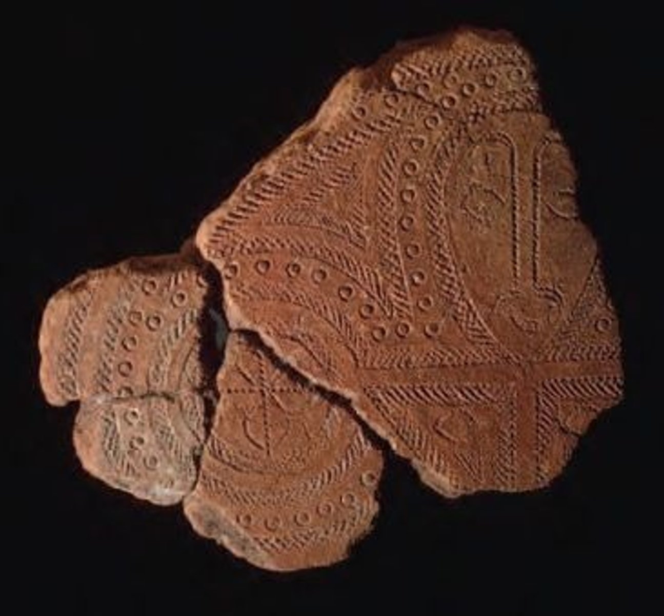<p>Solomon Islands; terra cotta; may have been used for serving or storing food; characteristic use of curved stamped patterns (dots, circles, and hatching); comb-like tomb used to male designed; one of oldest faces in Oceanic art</p>